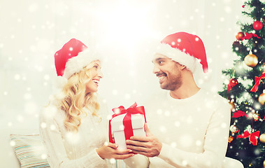 Image showing happy couple at home with christmas gift box