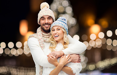 Image showing happy couple hugging over christmas lights