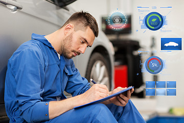 Image showing auto mechanic man with clipboard at car workshop