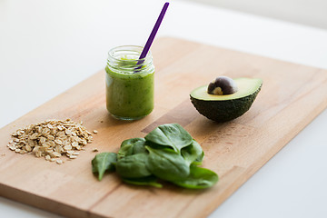 Image showing jar with puree or baby food on wooden board