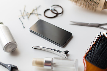 Image showing smartphone, scissors, brushes and other hair tools