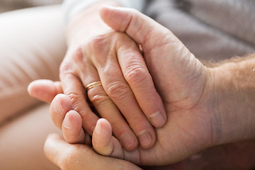 Image showing close up of senior couple holding hands