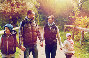 Image showing happy family with backpacks hiking