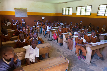 Image showing Children in uniforms in primary school classroom listetning to teacher in rural area near Arusha, Tanzania, Africa.
