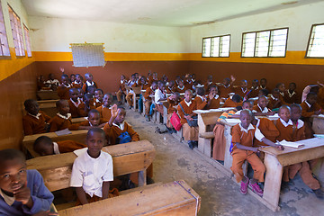 Image showing Children in uniforms in primary school classroom listetning to teacher in rural area near Arusha, Tanzania, Africa.