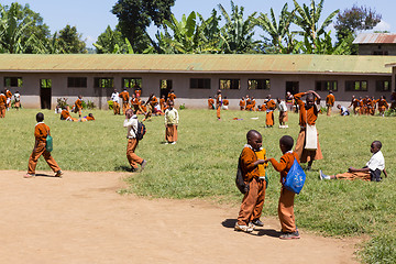 Image showing Children in uniforms playing in the cortyard of primary school in rural area near Arusha, Tanzania, Africa.