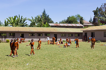 Image showing Children in uniforms playing in the cortyard of primary school in rural area near Arusha, Tanzania, Africa.