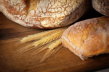 Image showing Fresh homemade bread assortment on old cutting board