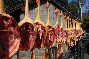 Image showing The meat drying outside on the sun