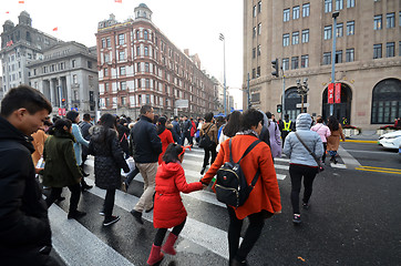 Image showing Commuters in a busy crosswalk at the Bund in Shanghai, China