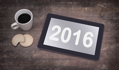 Image showing Tablet touch computer gadget on wooden table - 2016