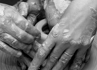 Image showing Beginner and teacher in process of making clay bowl on pottery w