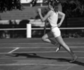 Image showing Black and white blurred view of running girl at stadium