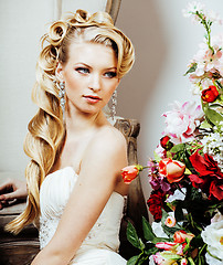 Image showing beauty young blond woman bride alone in luxury vintage interior with a lot of flowers 