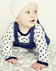 Image showing little cute baby toddler on carpet isolated close up smiling ado