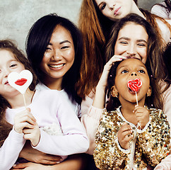 Image showing Lifestyle and people concept: young pretty diversity nations woman with different age children celebrating on birth day party together happy smiling, making selfie. African-american, asian and caucasi