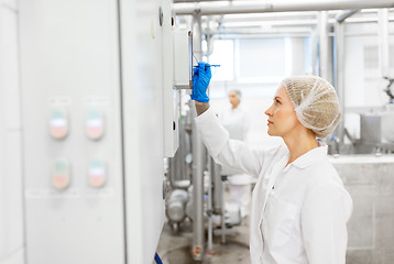 Image showing woman programming computer at ice cream factory