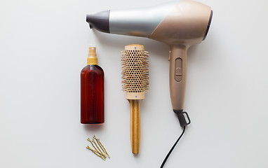 Image showing hairdryer, brush, hot styling hair spray and pins