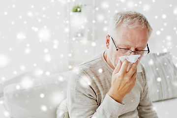 Image showing sick senior man with paper wipe blowing his nose