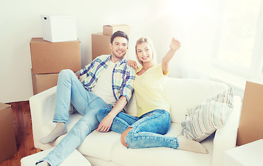 Image showing couple with boxes moving to new home and dreaming