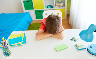 Image showing tired or sad student boy with smartphone at home