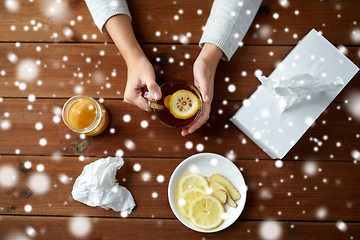 Image showing ill woman drinking tea with lemon and ginger