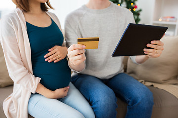 Image showing close up of man with pregnant wife shopping online