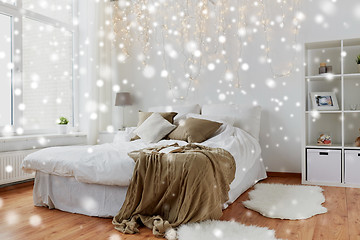 Image showing bedroom with bed and christmas garland at home