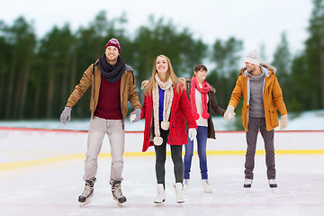 Image showing friends holding hands on outdoor skating rink