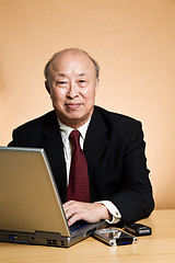 Image showing Working mature businessman