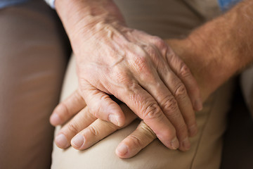 Image showing close up of senior couple holding hands