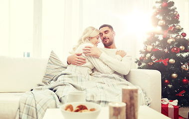 Image showing happy couple at home with christmas tree