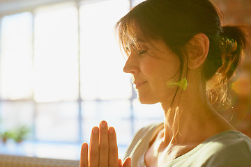 Image showing close up of yogi woman meditating at yoga studio