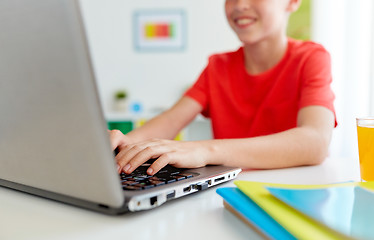 Image showing student boy typing on laptop computer at home