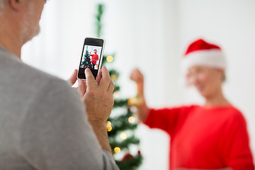 Image showing close up of senior man picturing wife at christmas