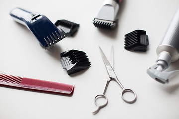 Image showing styling hair sprays, clippers, comb and scissors