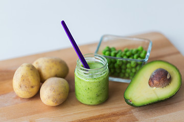 Image showing jar with puree or baby food on wooden board