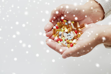 Image showing close up of old man hands holding medicine