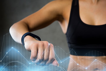 Image showing woman with heart-rate watch in gym