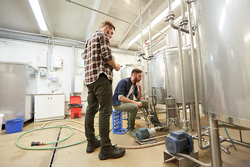 Image showing men with tablet pc at craft beer brewery filter