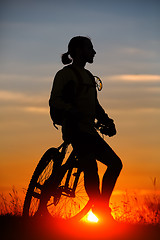 Image showing Silhouette of a bike on sky background