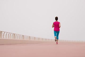 Image showing woman busy running on the promenade