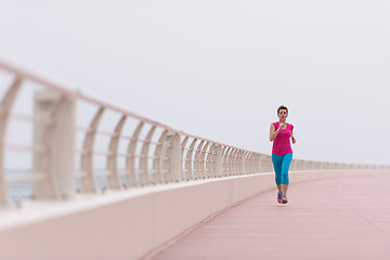 Image showing woman busy running on the promenade