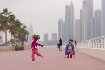 Image showing mother and cute little girl on the promenade