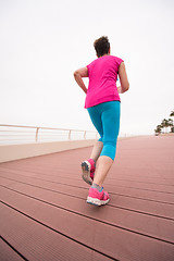 Image showing woman busy running on the promenade