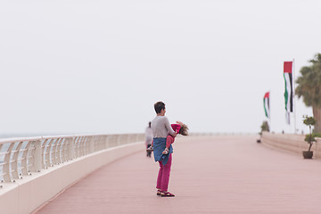 Image showing mother and cute little girl on the promenade by the sea