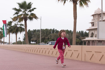 Image showing cute little girl on the promenade by the sea