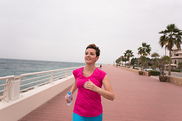 Image showing woman busy running on the promenade