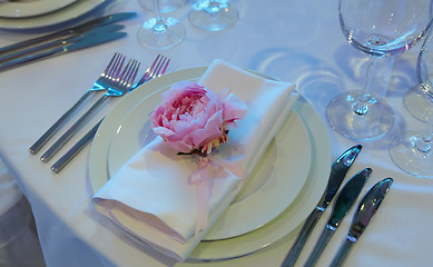 Image showing Spring table settings with fresh flower, napkin and silverware. Holidays background. Selective Focus.