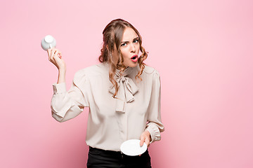 Image showing The serious frustrated young beautiful business woman on pink background